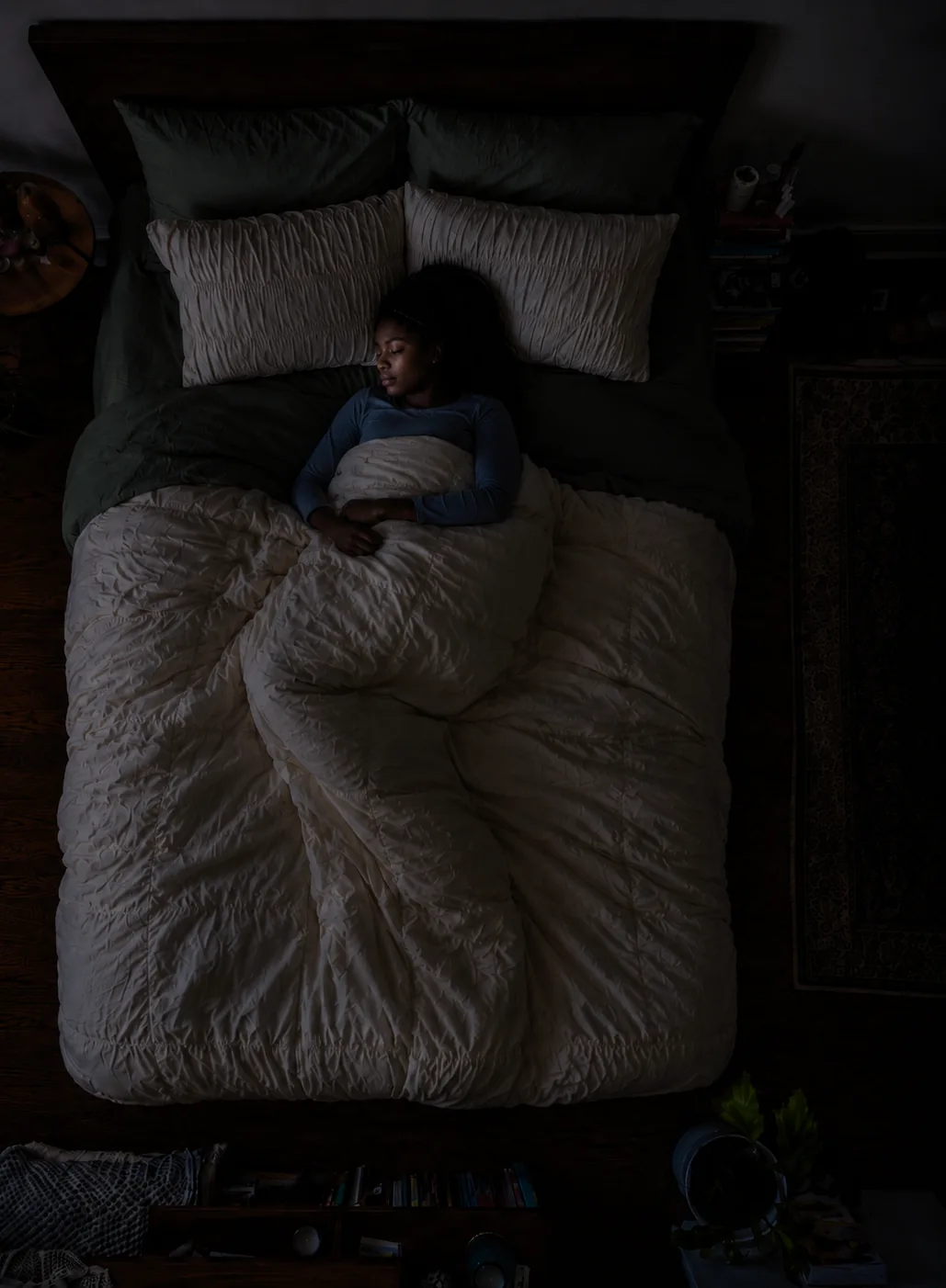 Deep asleep in a dark bedroom, the phone nowhere in sight