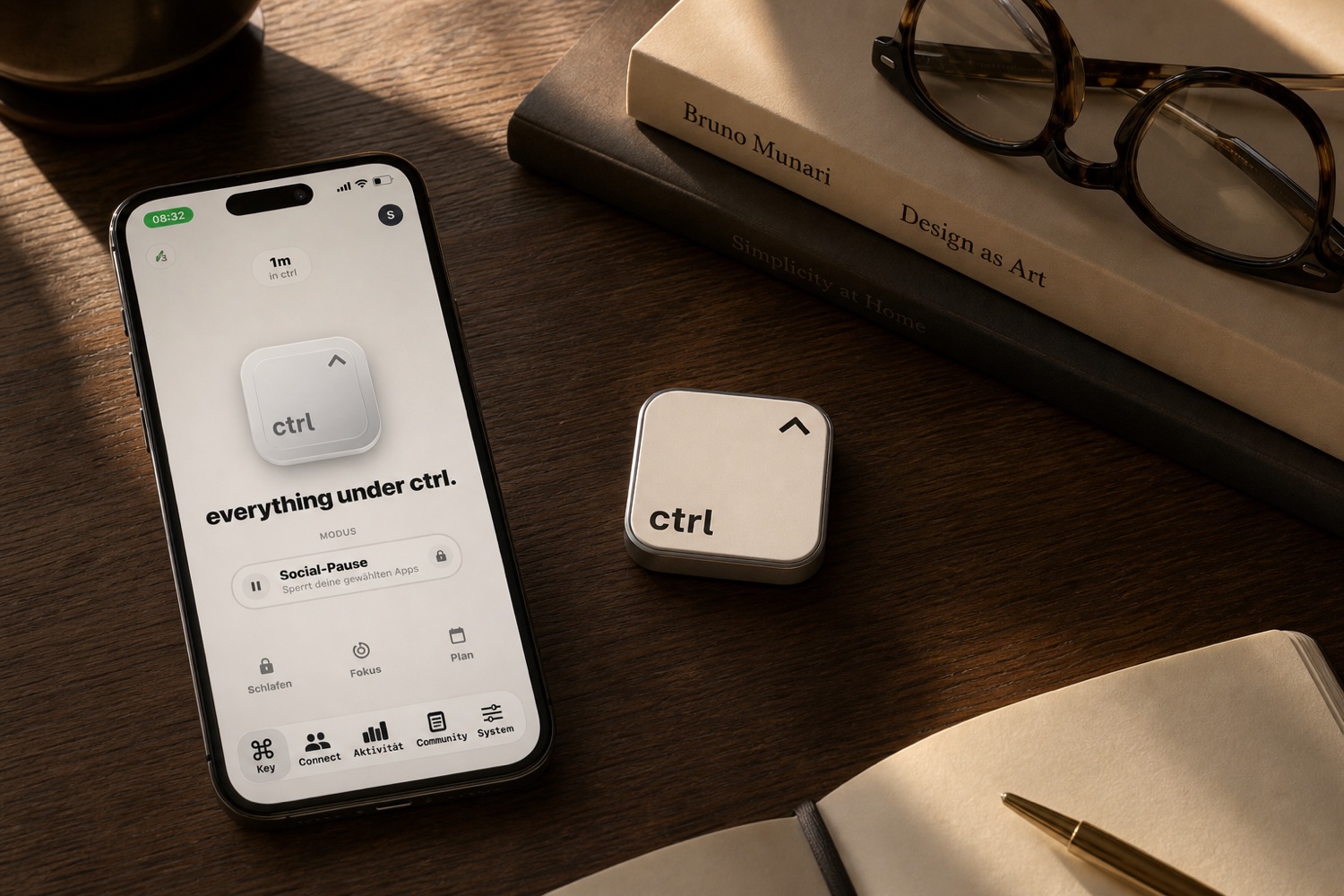 The ctrl key and an iPhone next to a design book on a calm desk