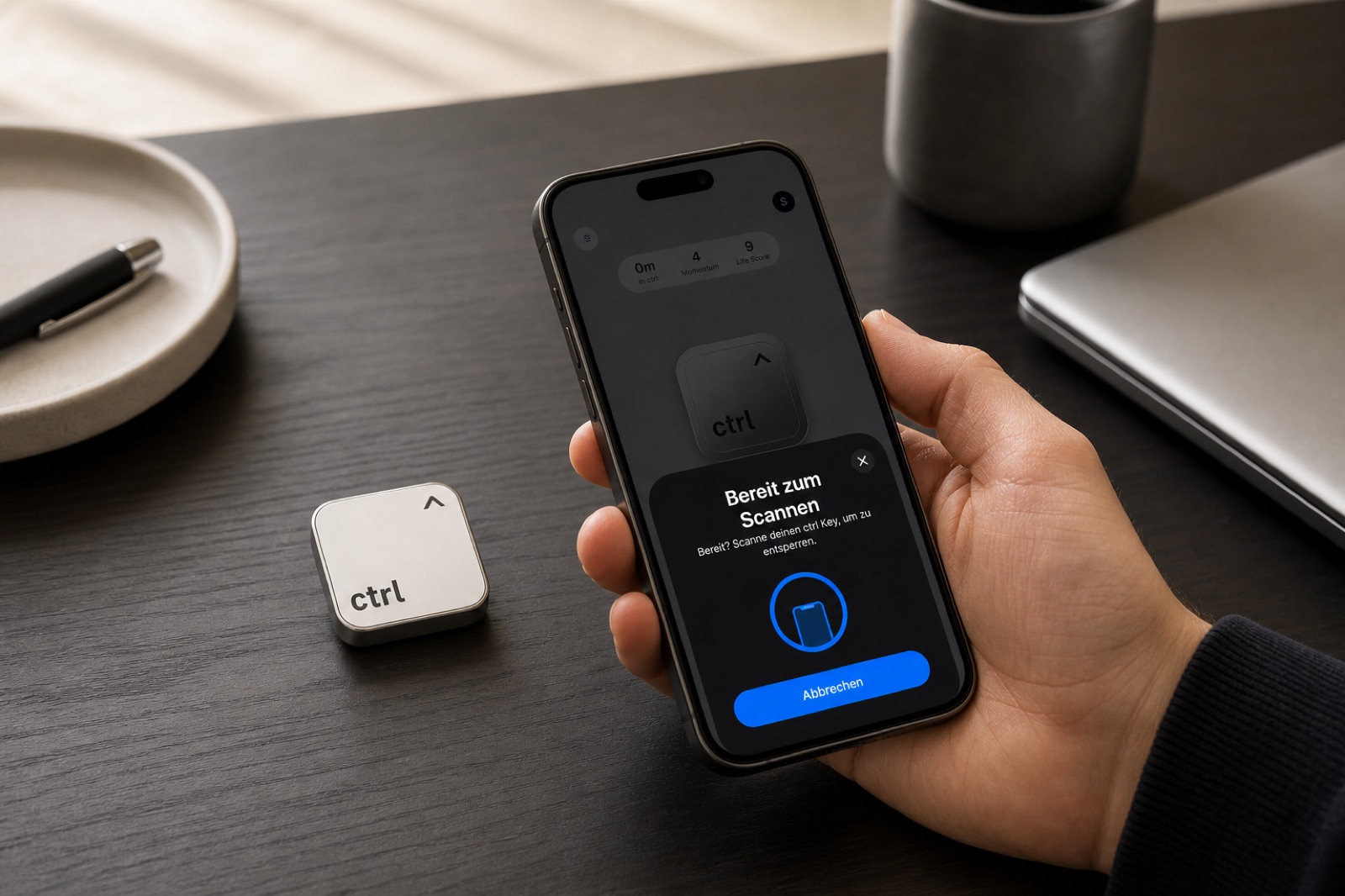 A hand scanning the ctrl key with an iPhone at a desk to start a focus session