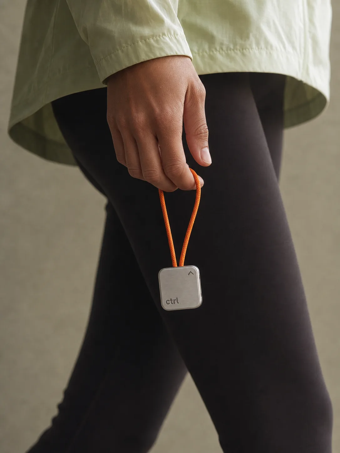 A person in motion, holding the ctrl key on its strap